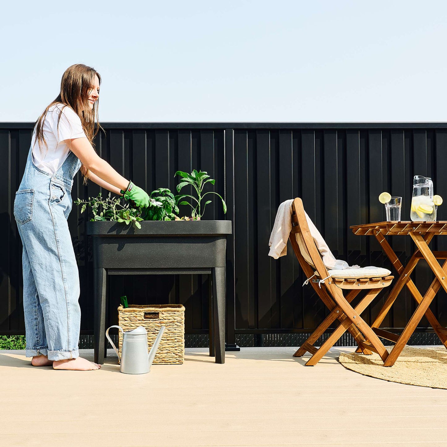 Raised garden bed with trellis and self-watering system