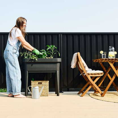 Raised garden bed with trellis and self-watering system
