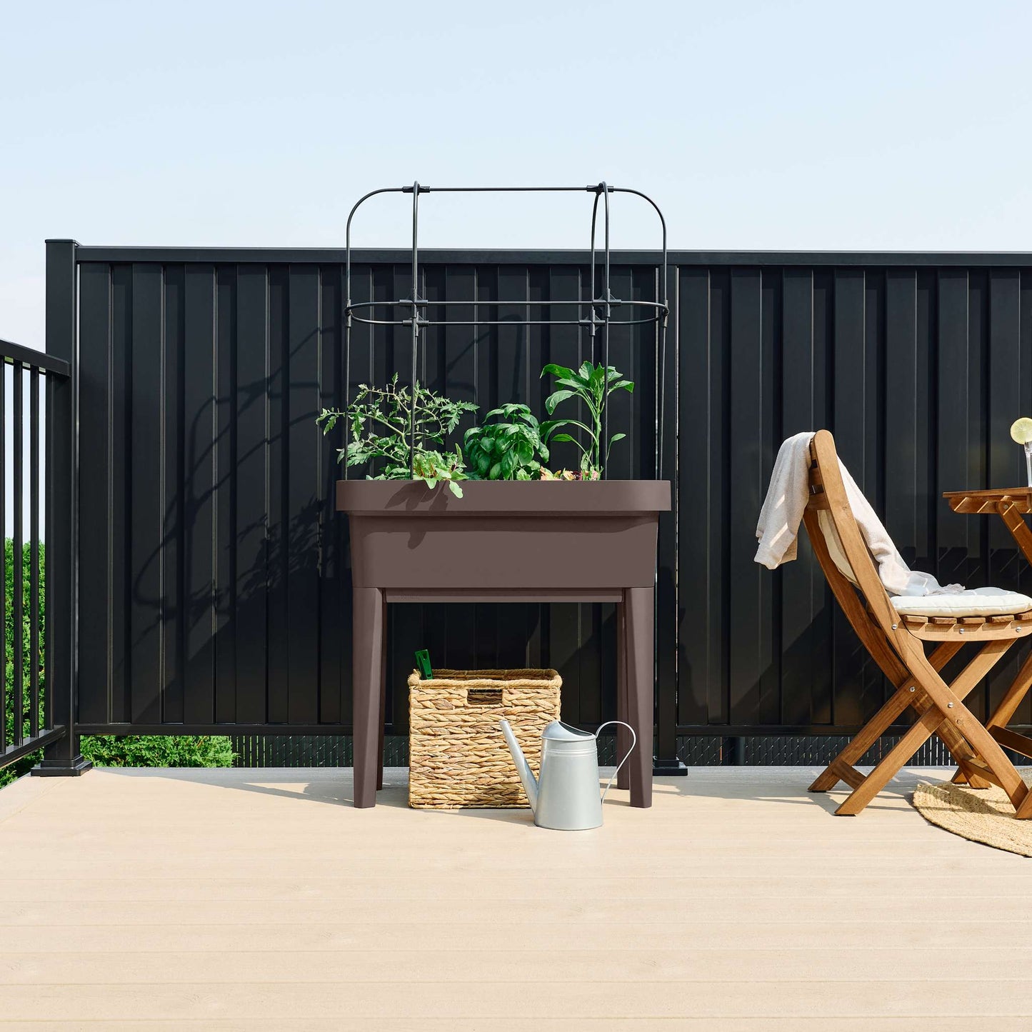 Raised garden bed with trellis and self-watering system