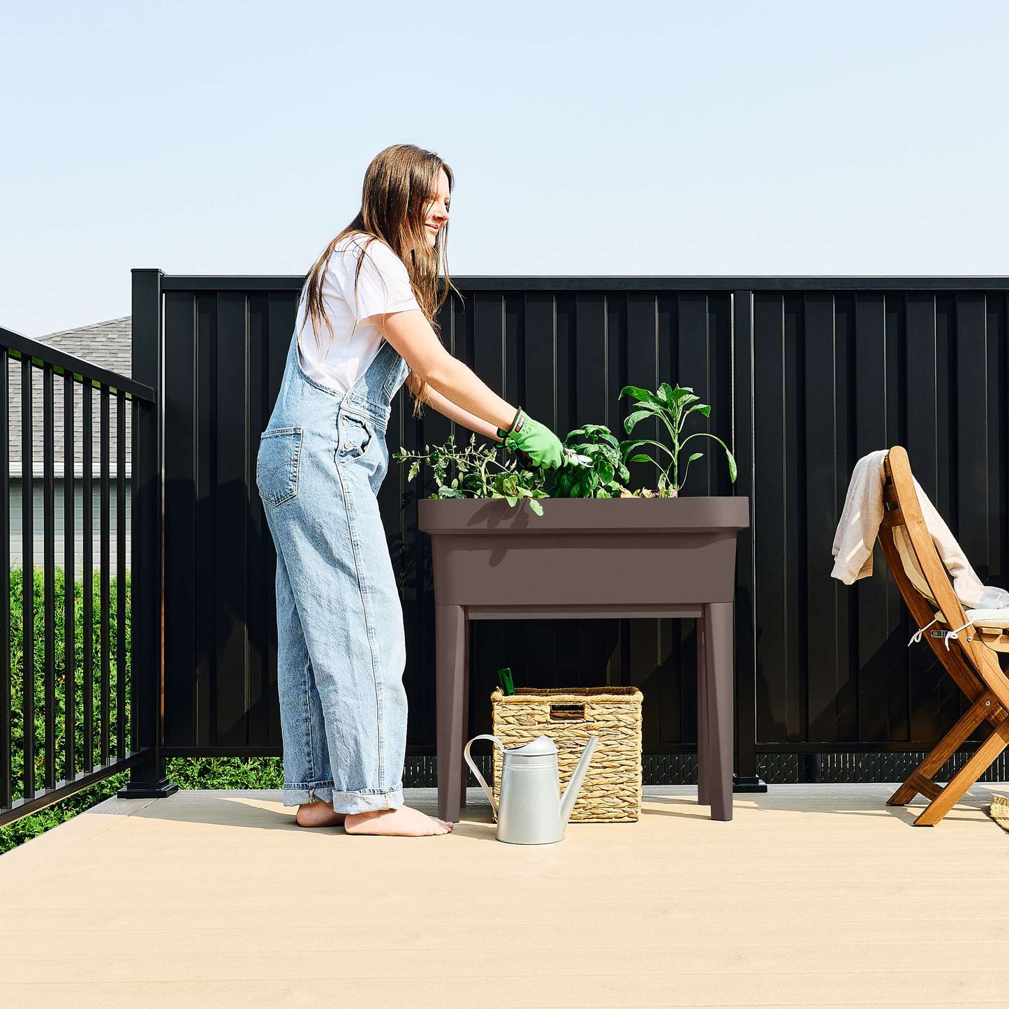 Raised garden bed with trellis and self-watering system